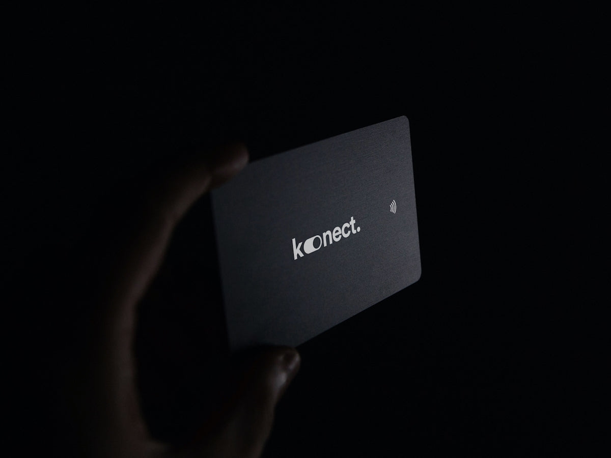 a person holding up a business card in the dark