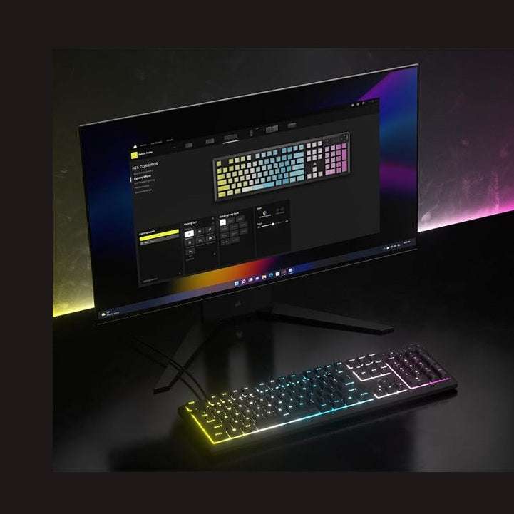 Corsair K55 CORE RGB membrane gaming keyboard on desk, black keys glowing multicolor